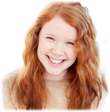 Smiling person with long red hair.